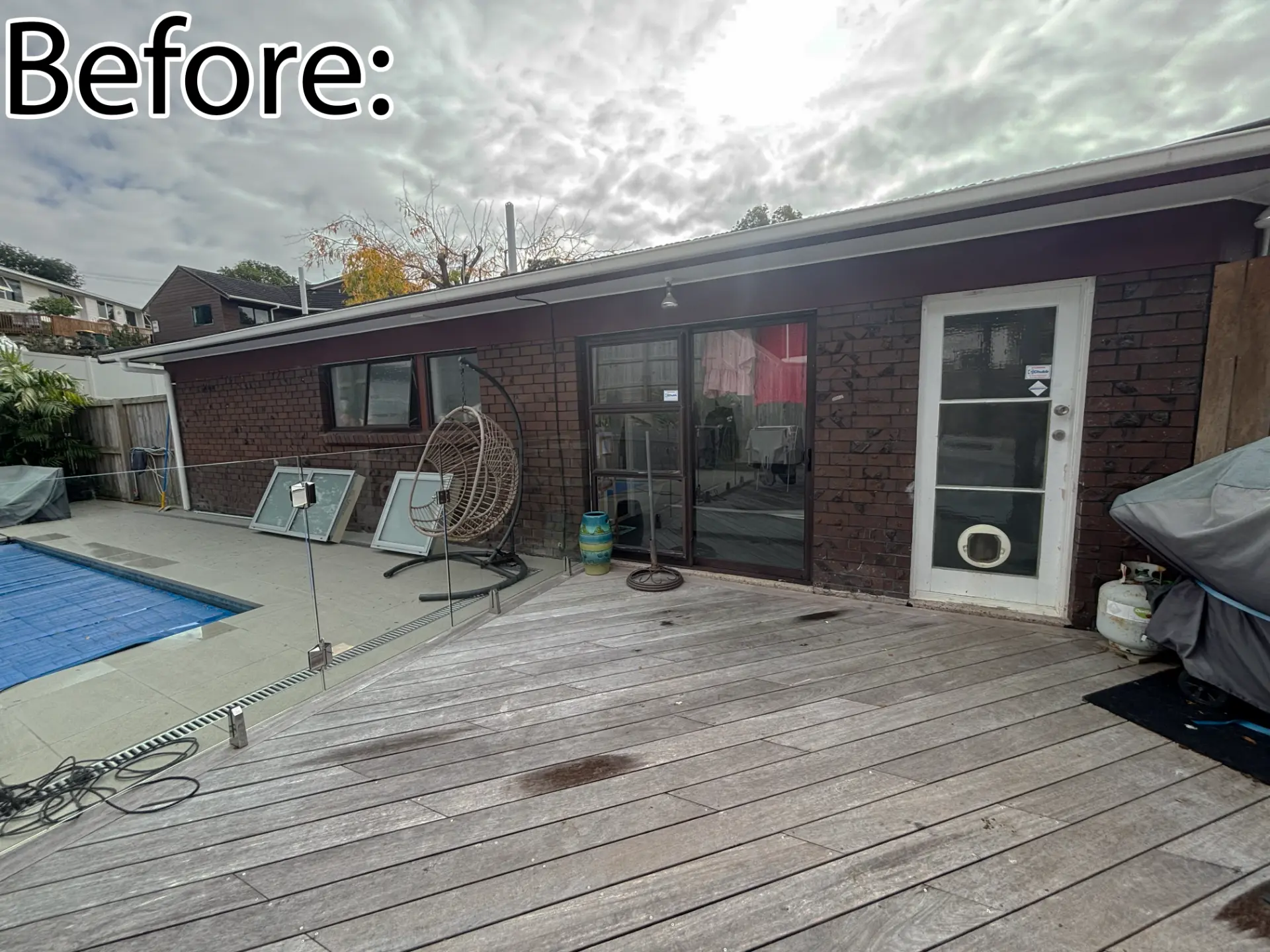 Selwyn Road poolside before: dated brown brick with old sliding door and entrance door