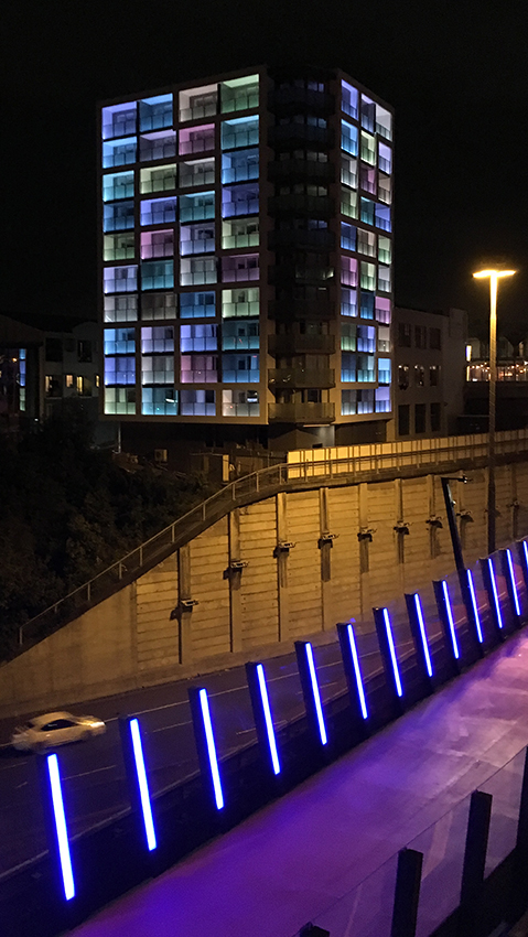 Unistay building at night with illuminated balcony glazing