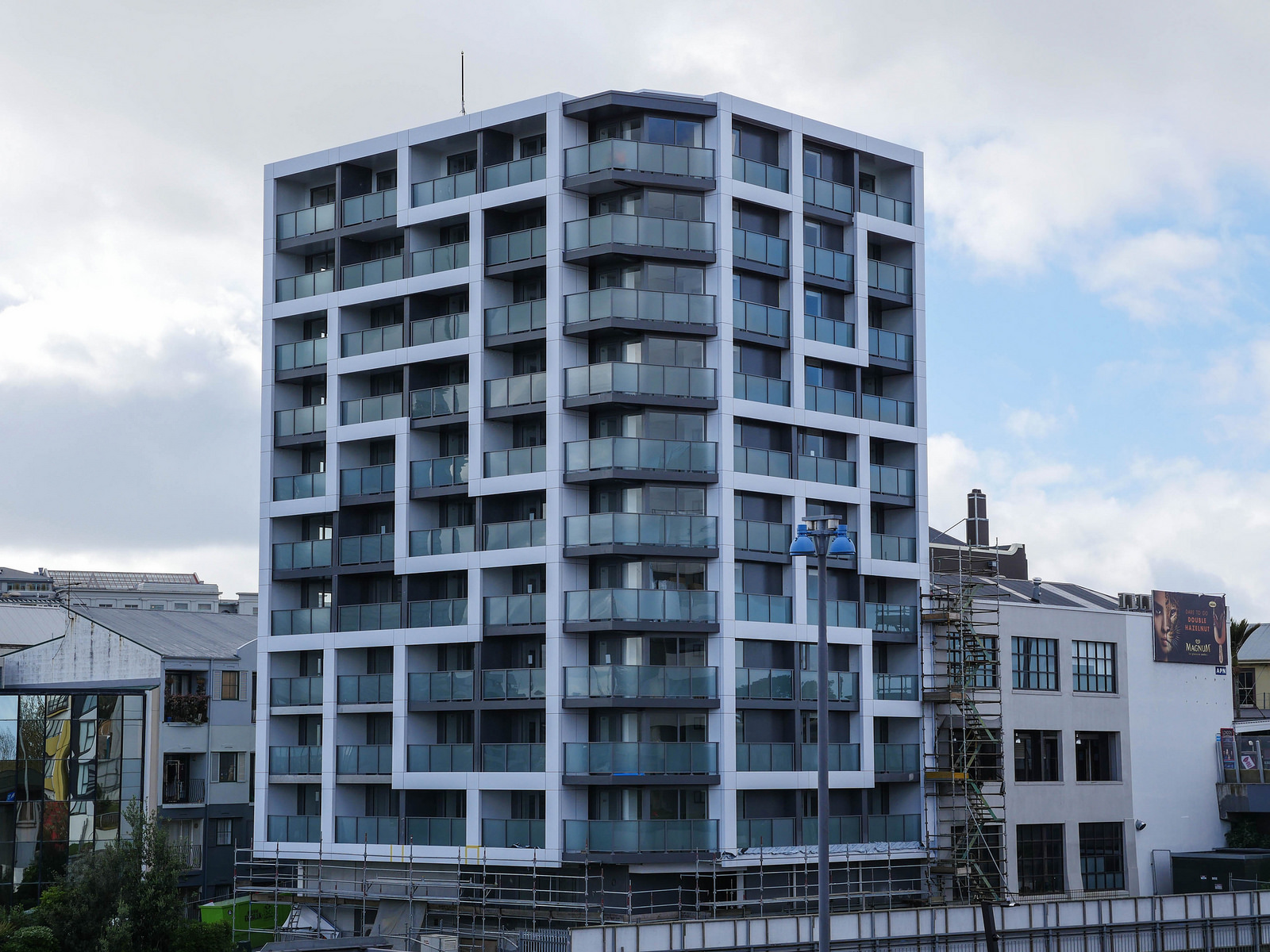Unistay tower facade with curved glass balconies and aluminium windows