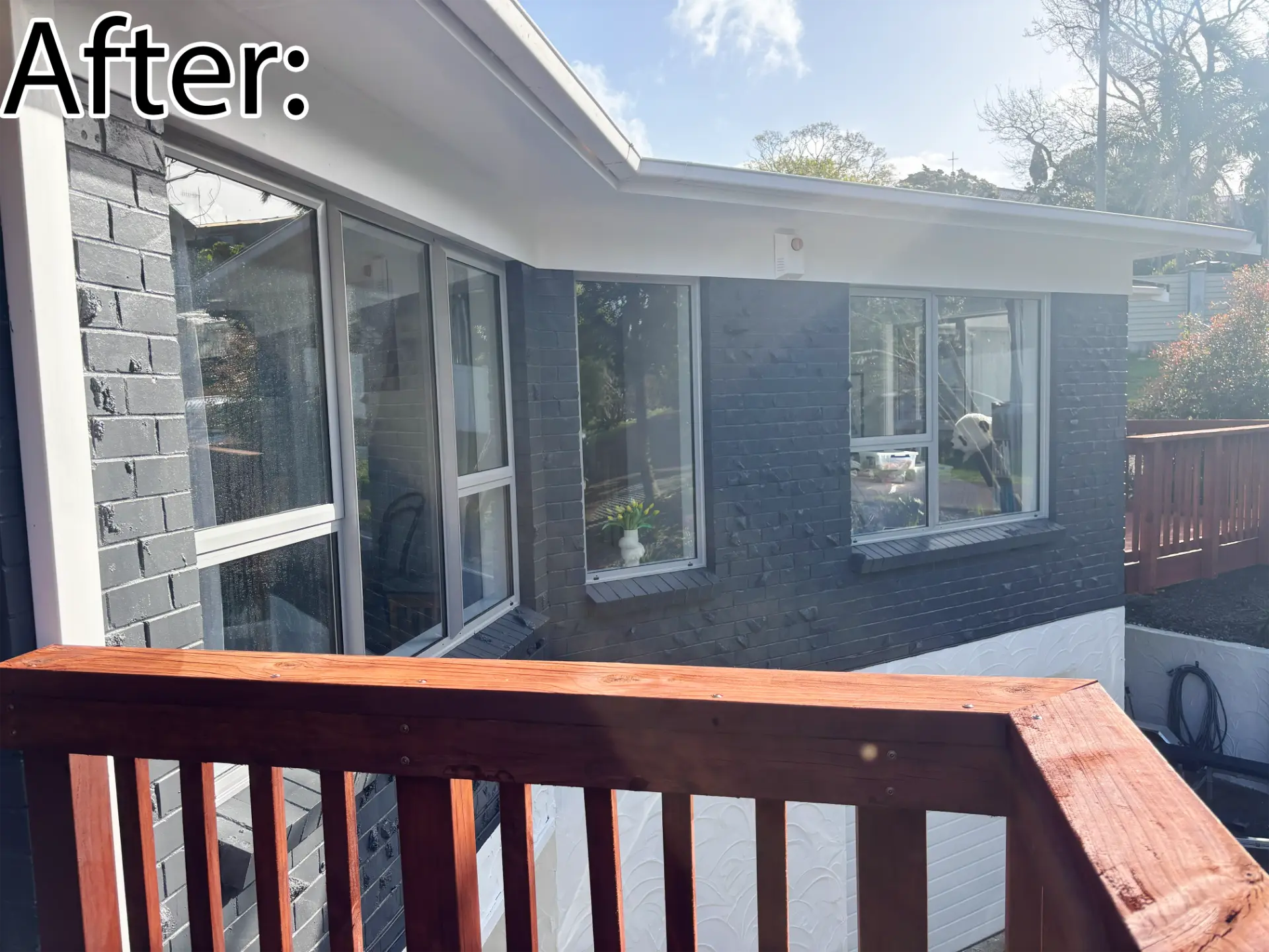 Selwyn Road deck corner after: grey painted brick with new white aluminium windows