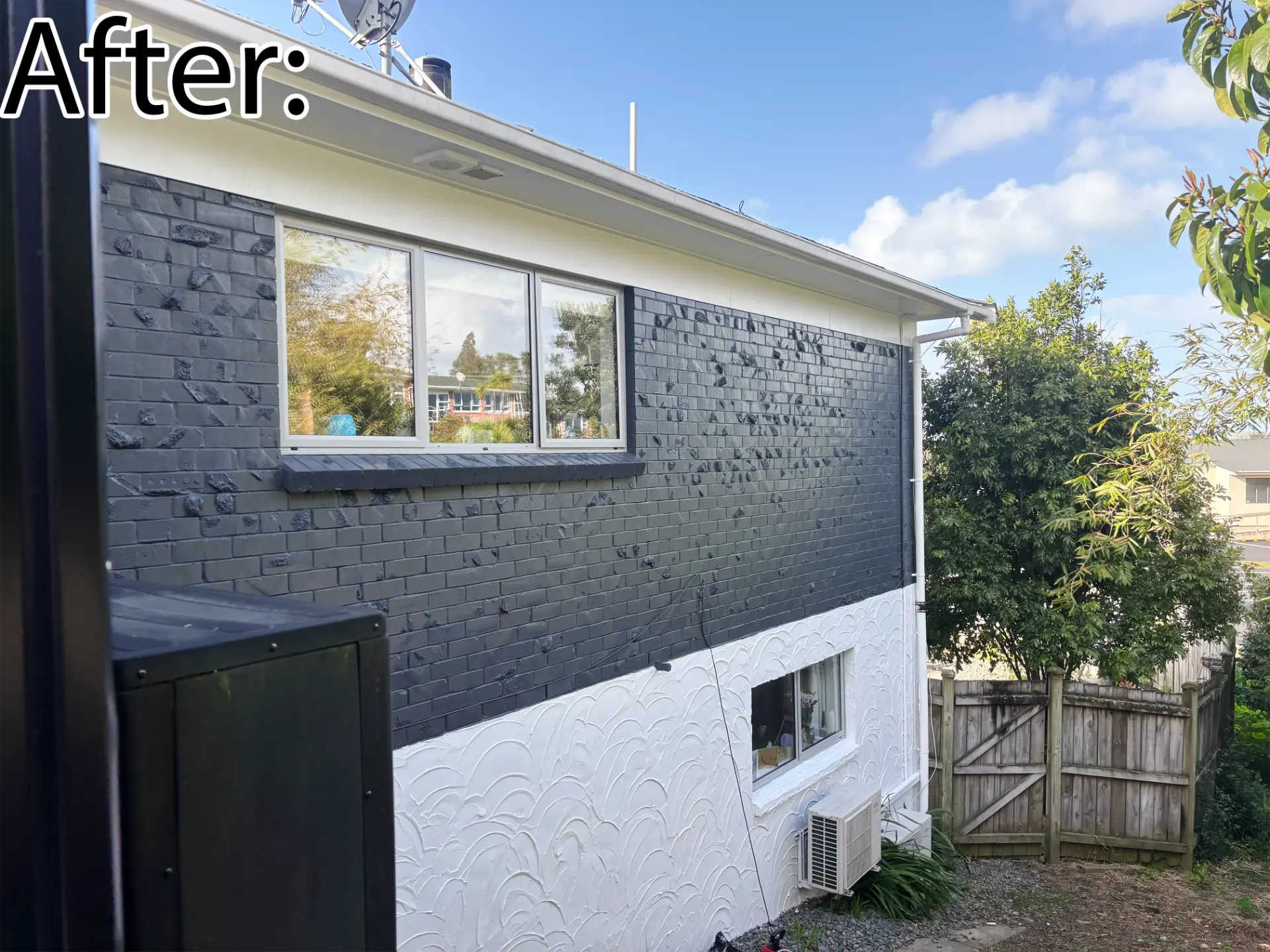 Selwyn Road side wall after: grey painted brick with white aluminium slider window