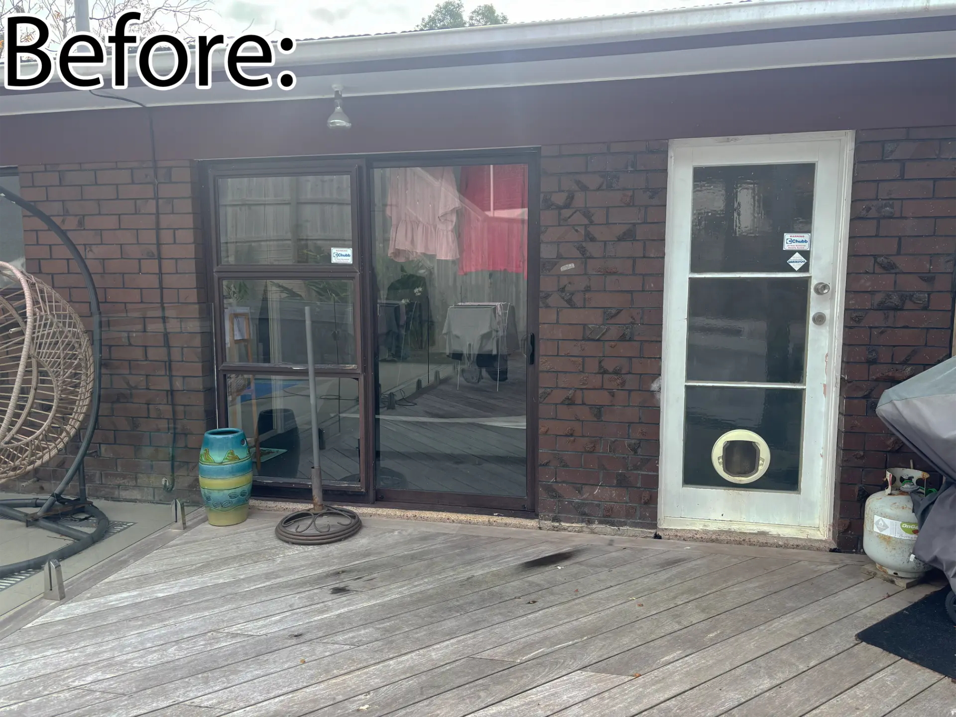 Selwyn Road close-up before: old dark sliding door and worn entrance door