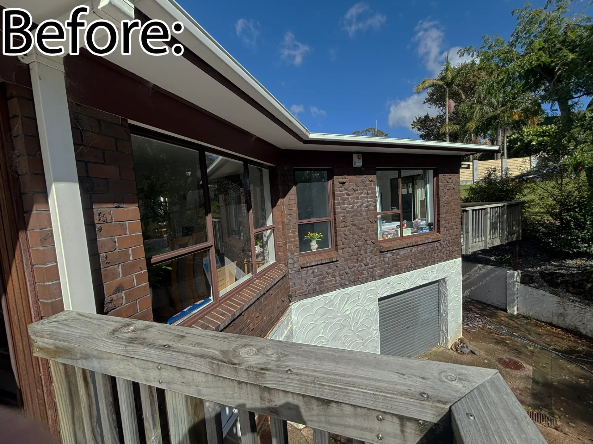 Selwyn Road deck corner before: brown brick and dark-framed windows