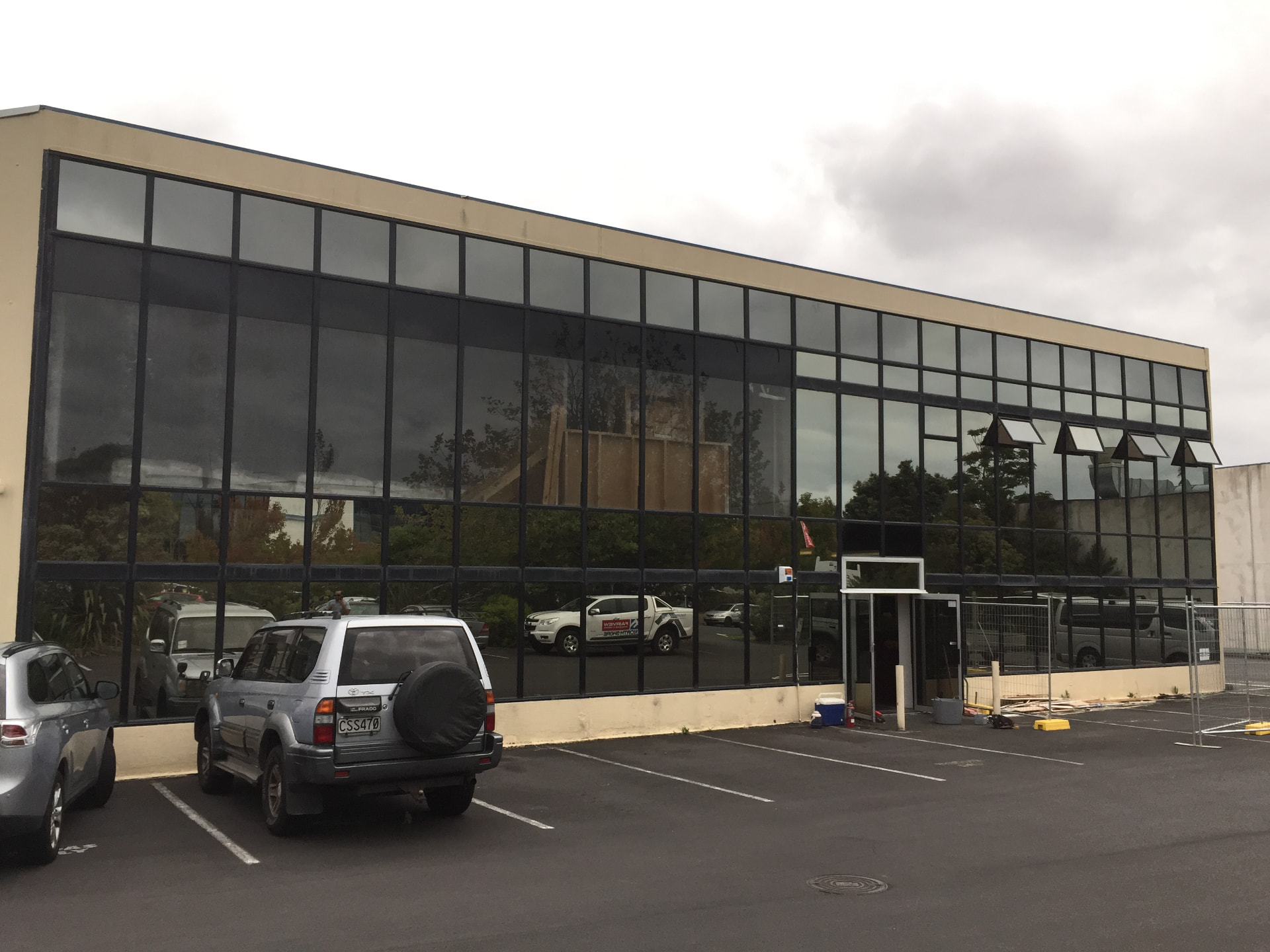 Commercial showroom facade with full-height aluminium glazing and louvre windows