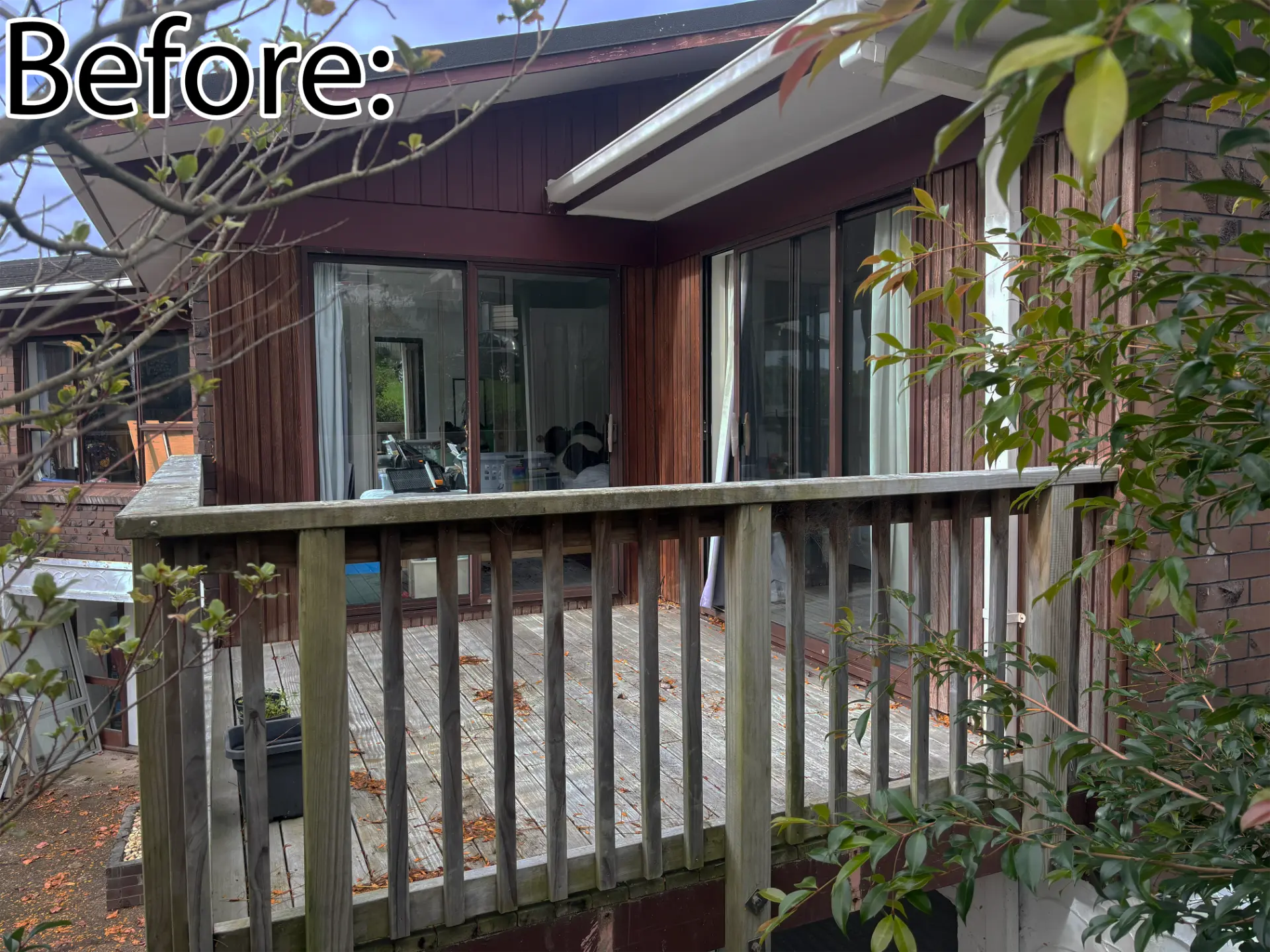 Selwyn Road lower deck before: weathered decking and maroon cladding with old brown sliders
